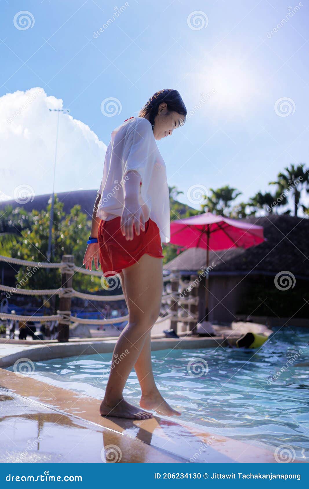 full lenghtÃ¢â¬â¹ portraitÃ¢â¬â¹ ofÃ¢â¬â¹ beautifulÃ¢â¬â¹ womanÃ¢â¬â¹ inÃ¢â¬â¹ white swimsuit standingÃ¢â¬â¹ byÃ¢â¬â¹ pool